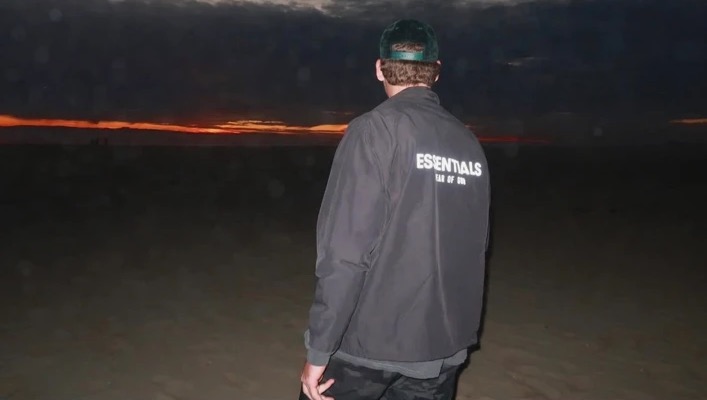 Cody Menk looking out at the ocean at sunset